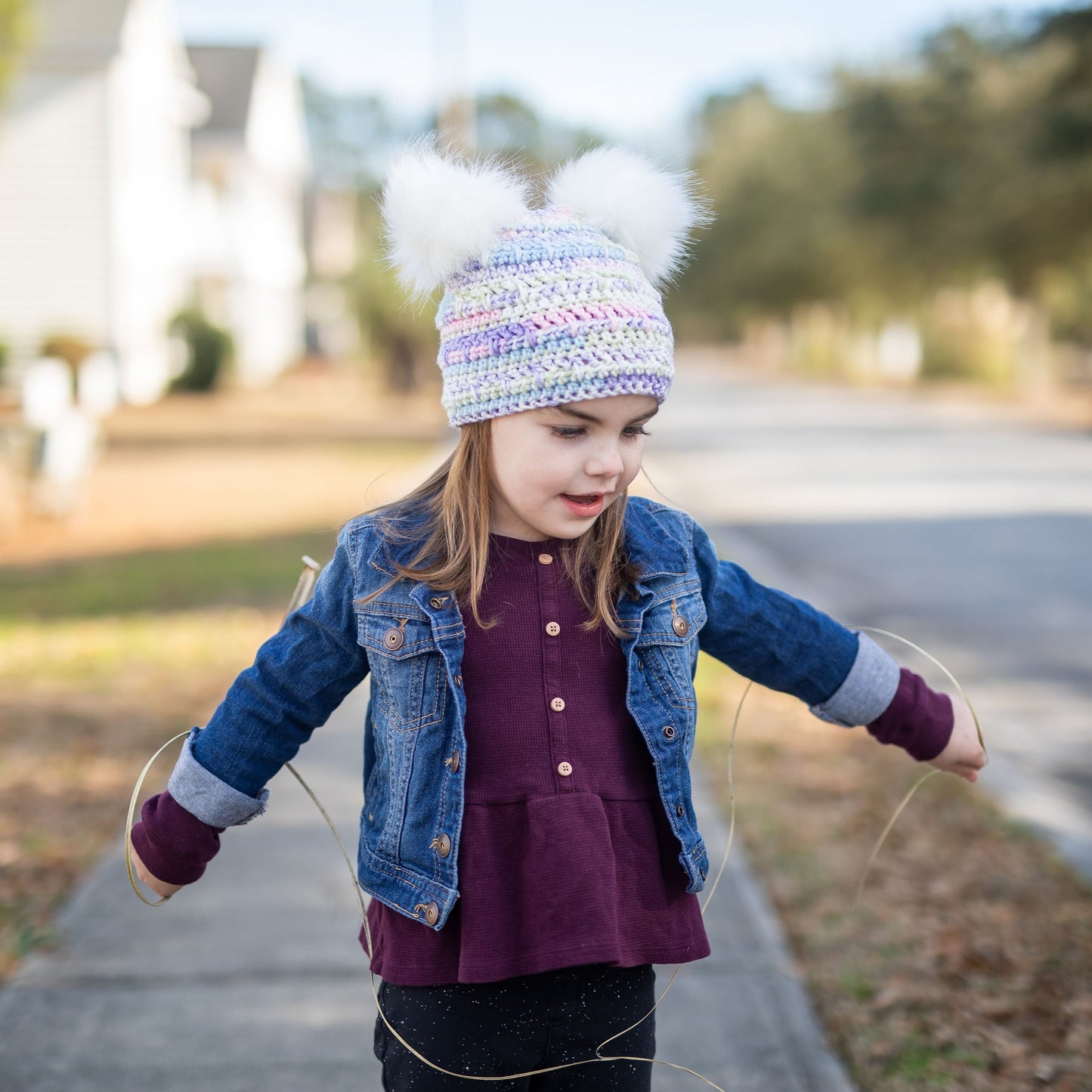 Pastel beanie with two white faux fur pom poms