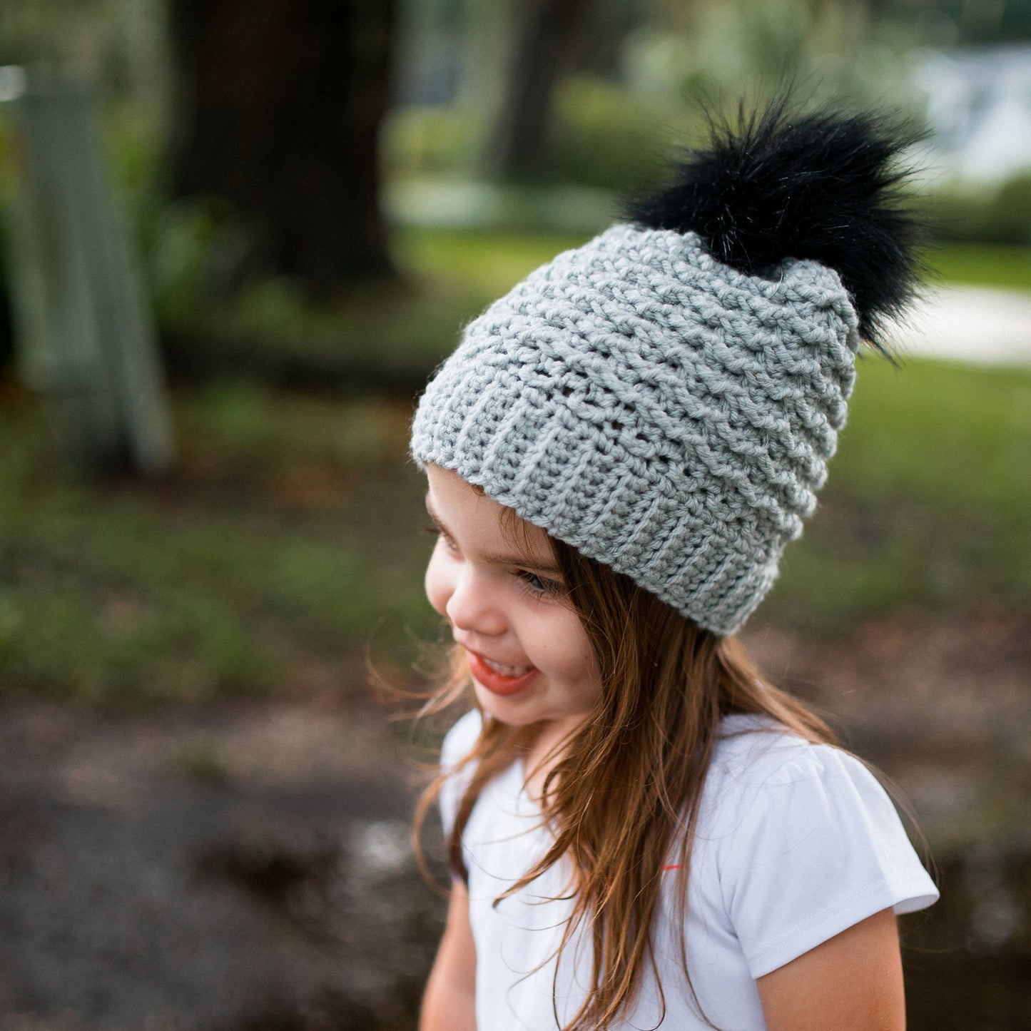 Grey mist beanie with a black pom pom