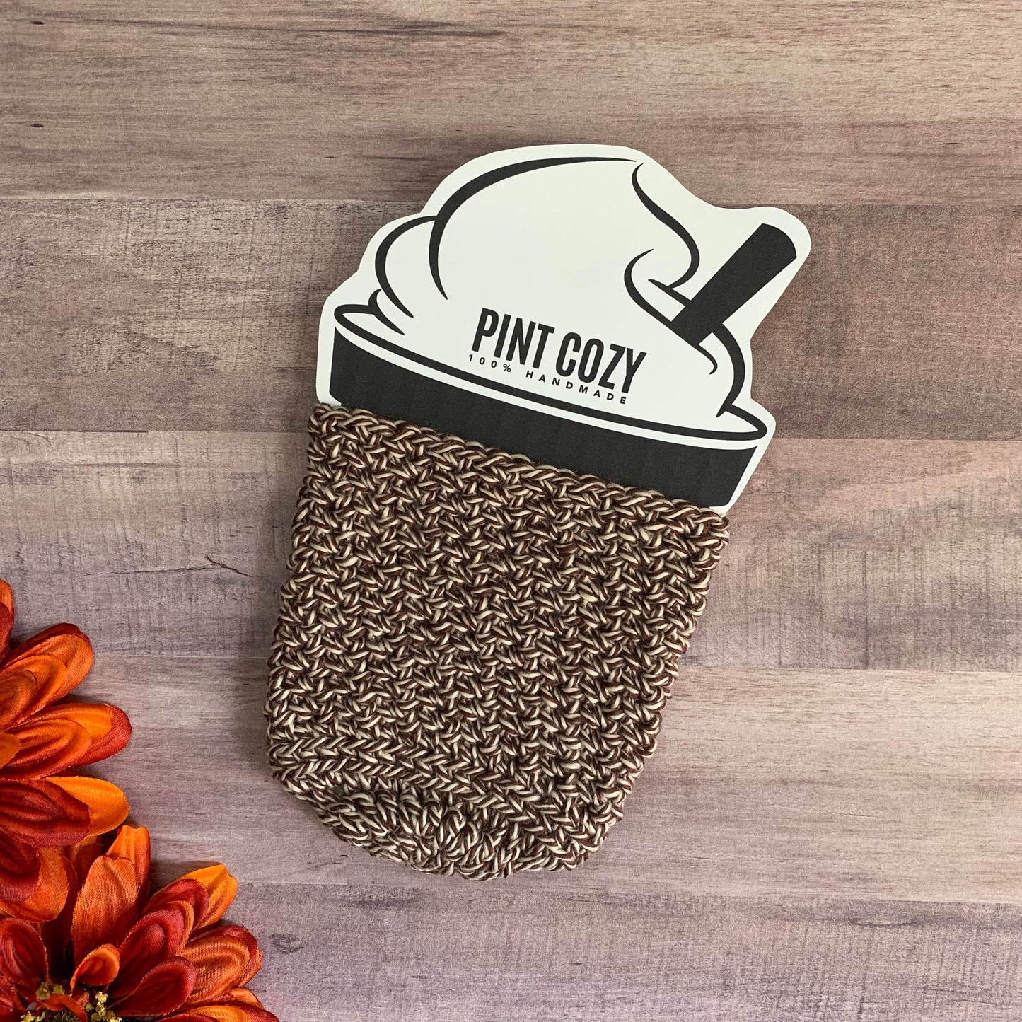 Flat lay of a brown and white pint size cozy