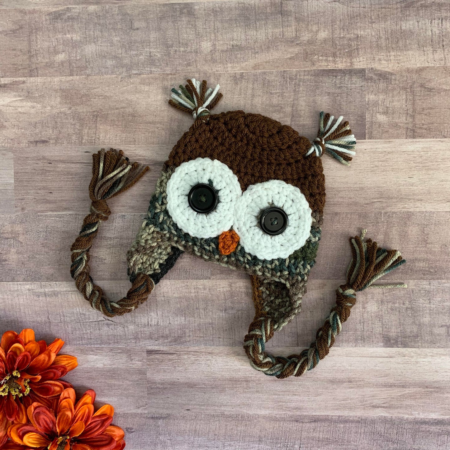 Camouflage owl beanie flat lay on a wooden background