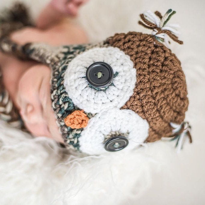 Top view of a newborn wearing this camouflage owl beanie