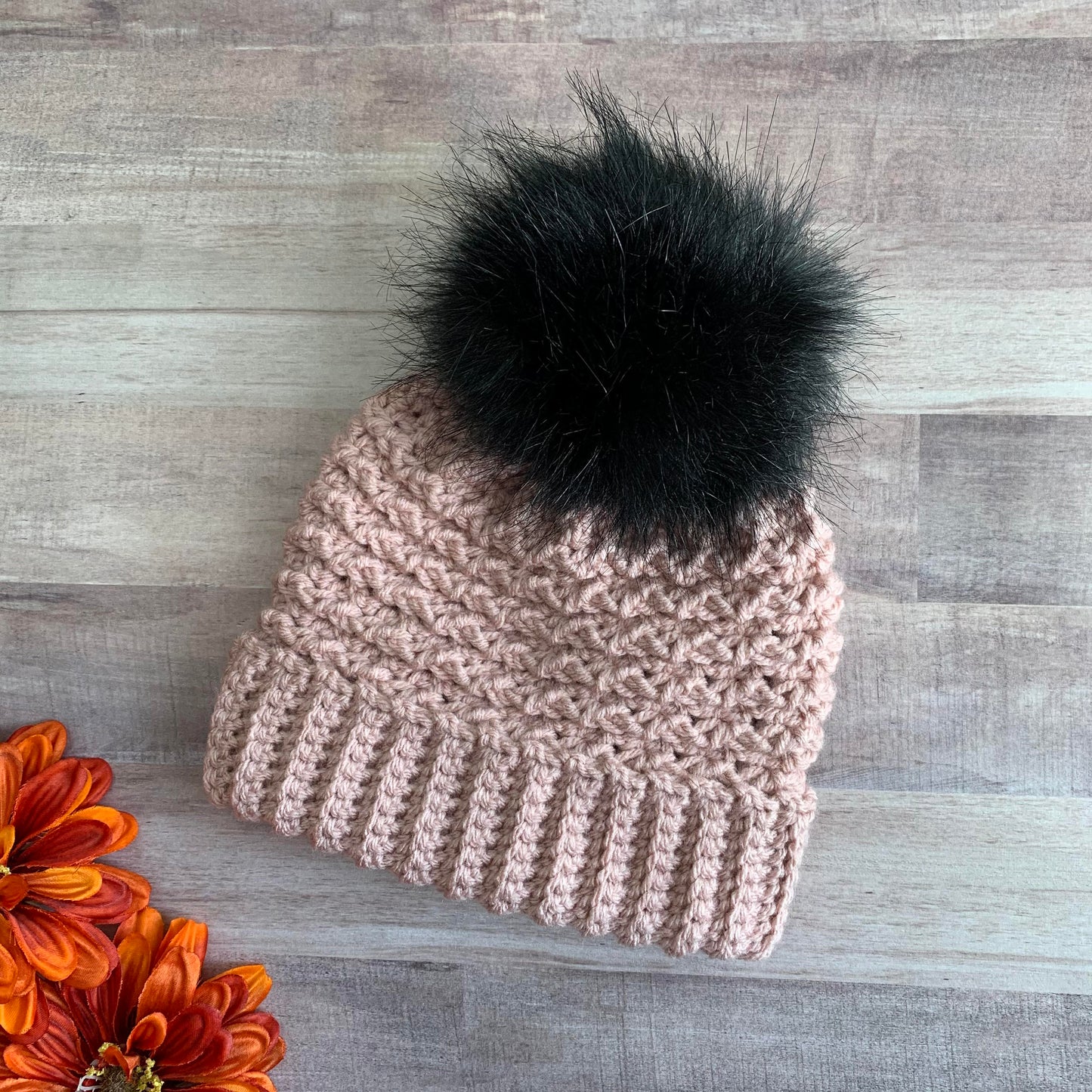 Blush double brim beanie with a black faux fur pom pom