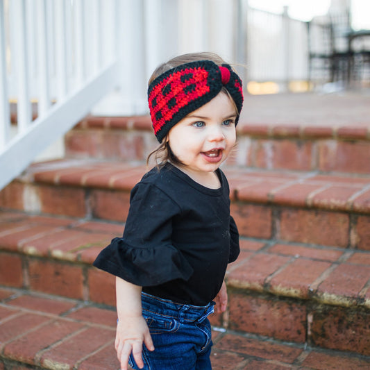 little girl wearing buffalo plaid ear warmer headband