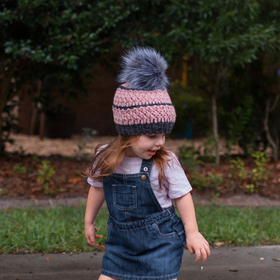 Grey and blush textured beanie with a grey faux fur pom pom