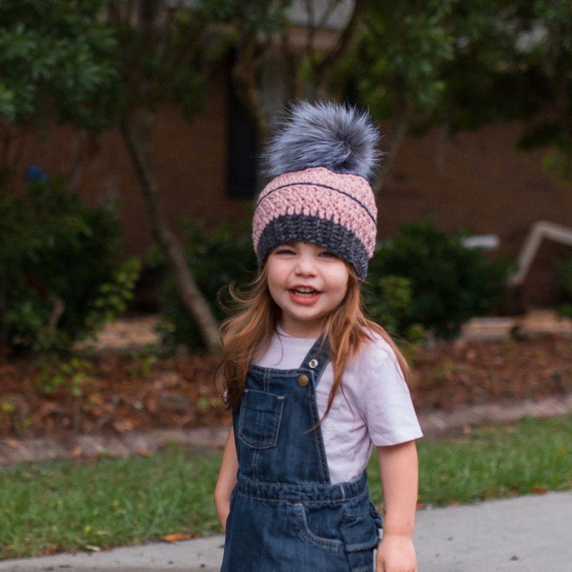 Grey and blush textured beanie with a grey faux fur pom pom