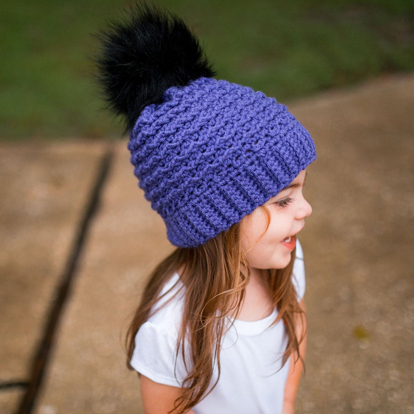 Purple beanie with black pom pom