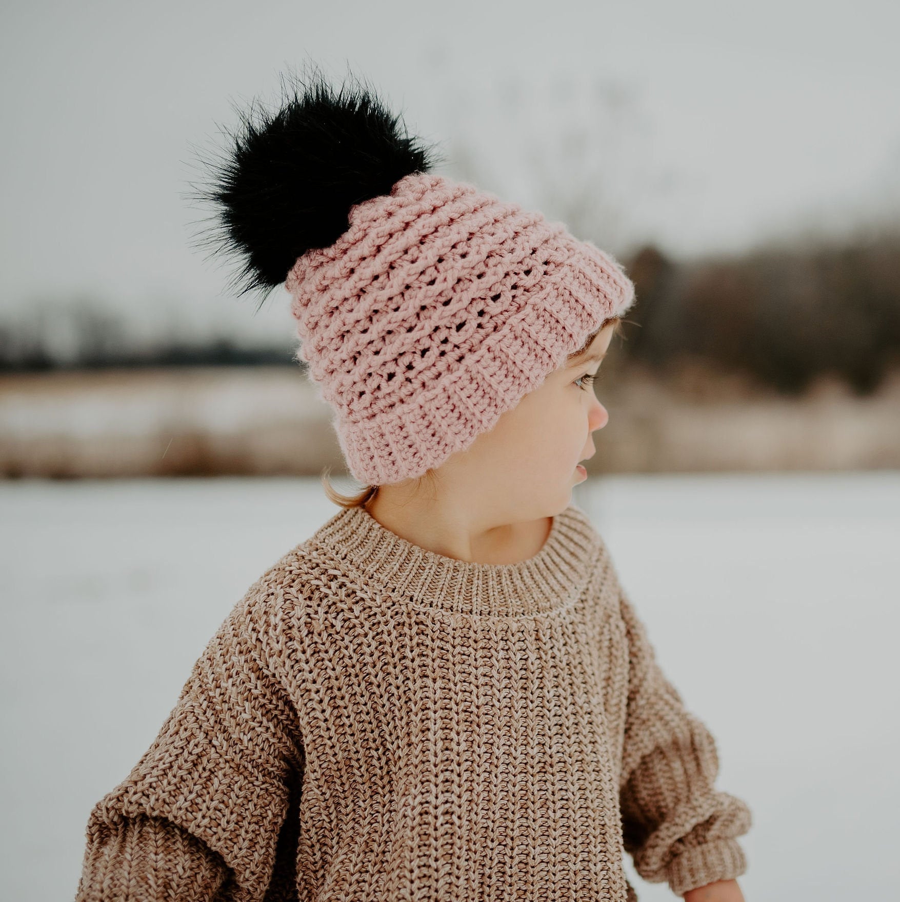 Blush double brim beanie with a black faux fur pom pom