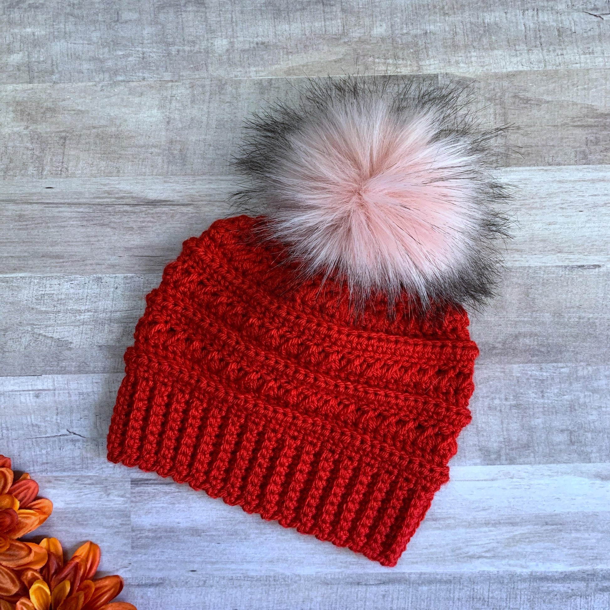 Red beanie with pink pom pom