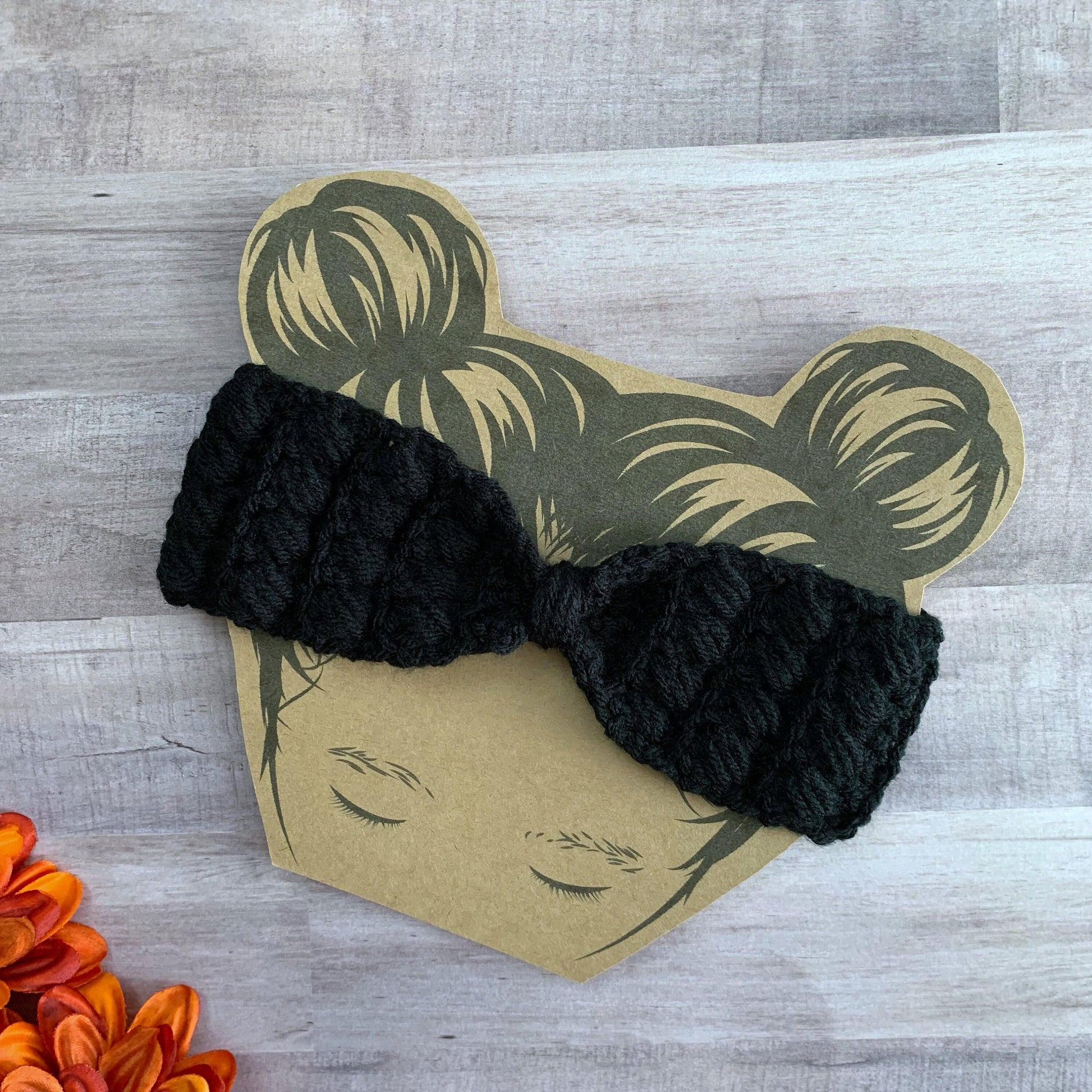 Black headband flat lay on a wooden background