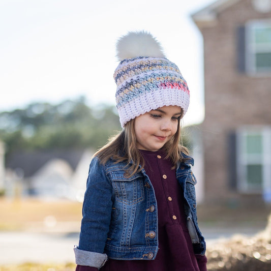 White and rainbow beanie with a white pom pom